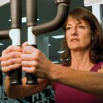 image of woman using pec fly machine