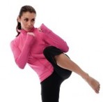 Women with raised fists preparing to kick forward