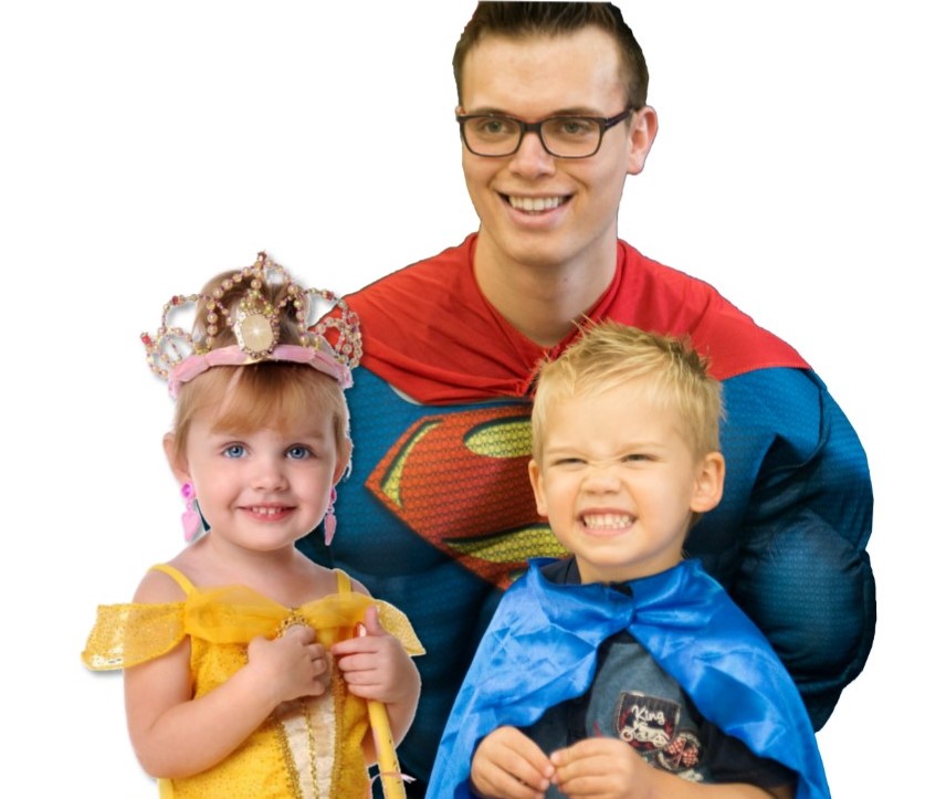 Man in superman outfit with a small boy and girl
