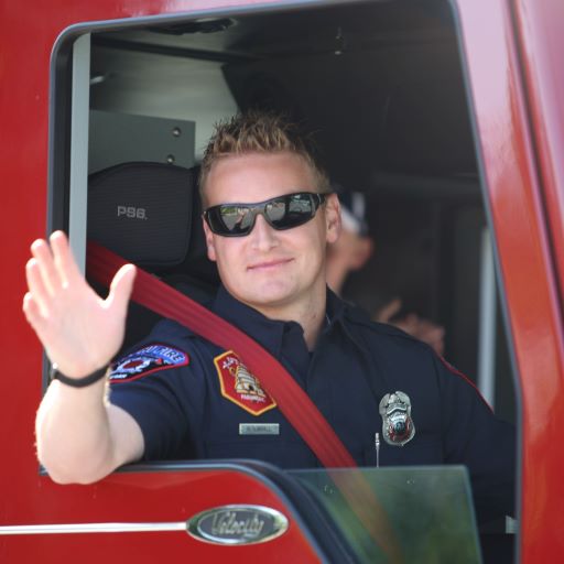 fire fighter waving from a fire truck