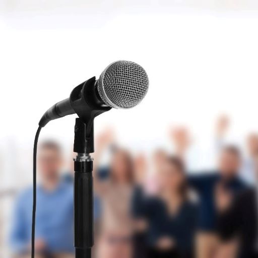 a microphone on a stand in front of an audience